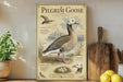 A vintage-style poster of a Pilgrim Goose is displayed on a wall, accompanied by a wooden cutting board, a potted plant, and some lemons.