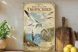 a poster of a red-billed Tropicbird, a tropical seabird, displayed on a wall. The poster includes a detailed illustration of the bird in flight and its natural habitat, with a coastal landscape in the background. The poster also includes text that describes the bird's appearance, behavior, and habitat.