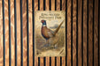 A vintage-style poster of a pheasant, featuring a ring-necked pheasant and a pheasant with a crest, displayed on a wooden wall.