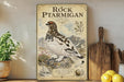 a vintage-style poster of a mountain bird, likely a pterodactyl, displayed on a shelf next to a wooden cutting board and some potted plants.