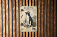a poster of a Rockhopper Penguin, which is a type of penguin, mounted on a wooden wall.