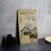 a metal sign with a detailed illustration of a seagull, labeled as Ross's Gull, standing on a rock.