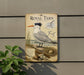 a decorative sign with a picture of a seagull, mounted on a wall.