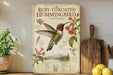 a poster of a Ruby-throated Hummingbird on a shelf, surrounded by various kitchen utensils and a potted plant.