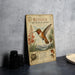 a vintage-style metal sign with illustrations and text about the Rufous Hummingbird, which is a small bird with a red, orange, and white coloration.