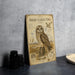 a metal sign with an illustration of a short-eared owl, accompanied by text and a bird's eye view of the owl.