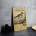 a metal sign with a detailed illustration of a spotted sandpiper bird, along with text providing information about the bird.
