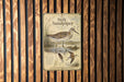 a poster of a sandpiper bird, which is mounted on a wooden wall.