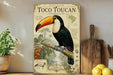 A vintage-style poster of a toucan, featuring a detailed illustration of the bird perched on a branch with various tropical elements in the background.
