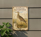 a vintage-style metal sign with an illustration of a bird, likely a sandpiper, standing in a field with grass and flowers.