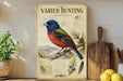 a vintage-style metal sign with a colorful illustration of a bird perched on a branch, surrounded by various botanical elements.