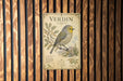 A vintage-style metal sign with a detailed illustration of a bird, likely a verdin, perched on a branch.