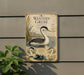 a sign with illustrations of birds, including a large bird with a long neck and a smaller bird, all set against a natural background.