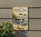 A vintage-style sign for Western Grebe, a type of water bird, is displayed on a wall.