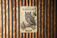 a poster of a Western Screech- Owl, which is a type of owl native to North America. The poster is mounted on a wooden wall with vertical slats.