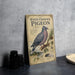 A vintage-style illustration of a white-crowned pigeon on a branch, accompanied by text and a map, is displayed on a wall.