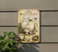 a vintage-style metal sign with illustrations and text, mounted on a wall next to a plant.