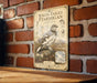 a vintage-style metal sign with a detailed illustration of a white-tailed pteranigan bird, mounted on a brick wall.