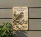 a vintage-style metal sign with illustrations of birds, including a white-throated sparrow, mounted on a wall.
