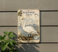 a vintage-style metal sign with an illustration of a swan, mounted on a wall.