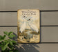 a vintage-style sign with illustrations of two white cranes standing in a field, surrounded by greenery.