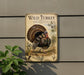 A metal sign featuring a detailed illustration of a wild turkey, with the title "Wild Turkey" prominently displayed.