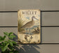 a vintage-style metal plaque with an illustration of a bird, likely a coastal wader, standing on a beach.