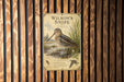 A vintage-style poster of a bird, likely a species of wading bird, is displayed on a wooden wall.