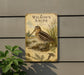 A vintage-style metal sign featuring an illustration of a bird, likely Wilson's Snipe, standing in a natural setting.