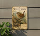 A vintage-style metal sign featuring a detailed illustration of a brown bird perched on a branch, surrounded by foliage, against a gray wall.