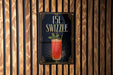 A sign for a cocktail called "151 Swzzle" is displayed on a wooden wall.