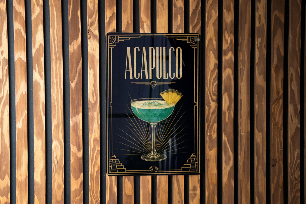 a poster or sign with the word "ACAPULCO" prominently displayed, along with an illustration of a cocktail glass containing a green drink and a slice of lemon.