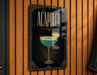 A sign for "Acapulco" cocktail is displayed on a wooden wall.