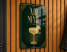 a sign with the text "AIR MAIL" and an illustration of a cocktail glass with a lime slice.