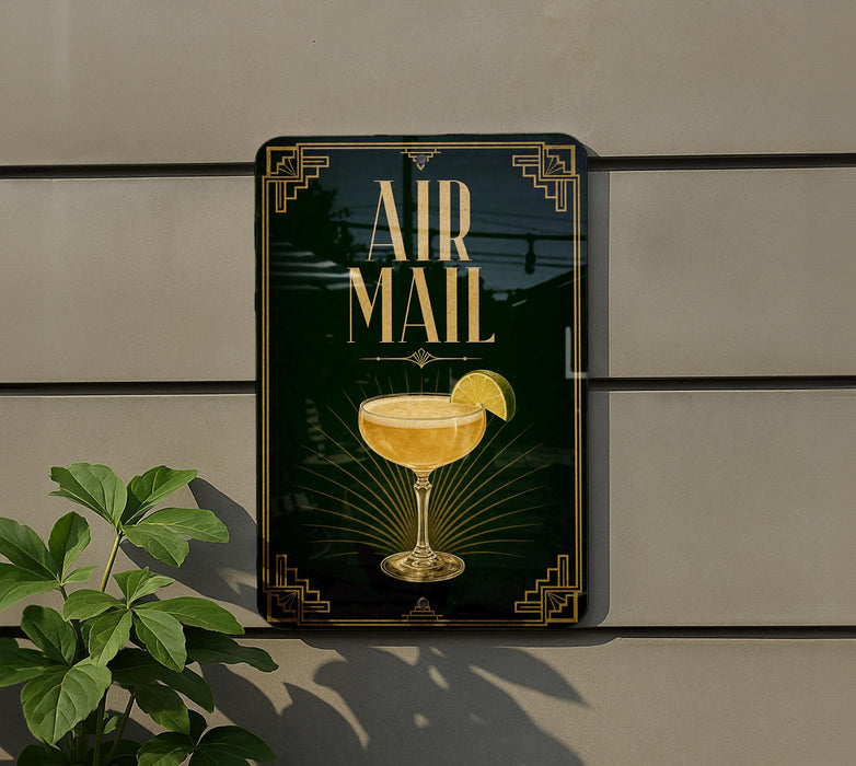 a sign with the text "AIR MAIL" and an illustration of a cocktail glass with a lime slice.