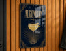A sign for "Algonquin" cocktail hanging on a wooden wall.