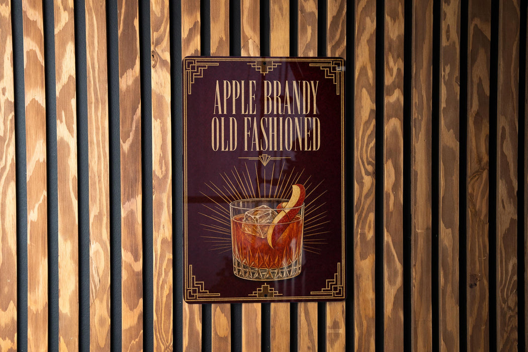 A sign for Apple Brandy Old Fasioned whiskey, featuring an illustration of a glass of the drink with a slice of apple on the rim.