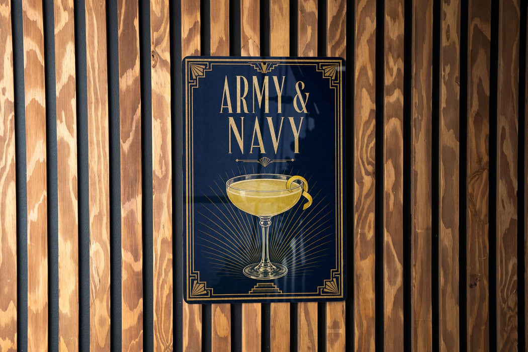 A poster with the text "ARMY & NAVY" and an illustration of a cocktail glass is displayed on a wooden wall.