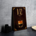 a poster or sign with a picture of a layered drink, possibly an espresso or cappuccino, along with the text "B-52".