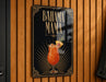 A sign for a tropical drink called "BAHAMA MAMA" is displayed on a wooden wall.