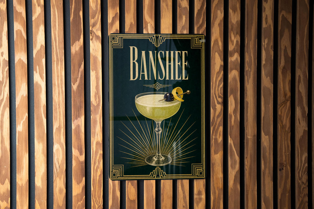 A poster with the word "BANSHEE" and an illustration of a cocktail is displayed on a wooden wall.