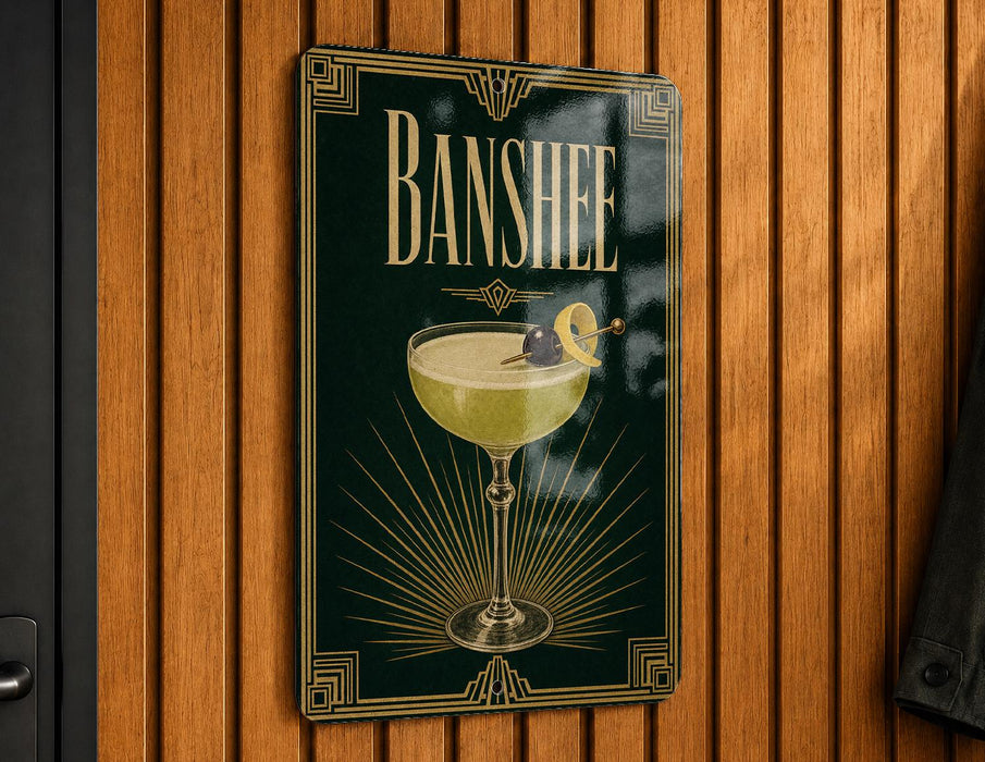 A decorative sign for "Banshee" cocktail, featuring a glass of yellow liquid with a lemon twist and a cherry on top, mounted on a wooden wall.