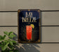 a sign for a drink called "Bay Breeze" with a glass illustration and a lemon slice.