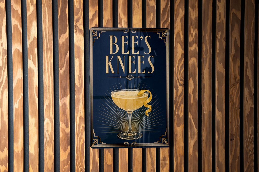 A sign that reads "BEES KNEEES" is displayed on a wooden wall.