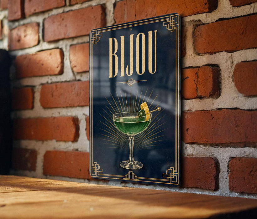 A poster with the word "Bjou" displayed prominently, featuring a glass of green liquid and a lemon slice.