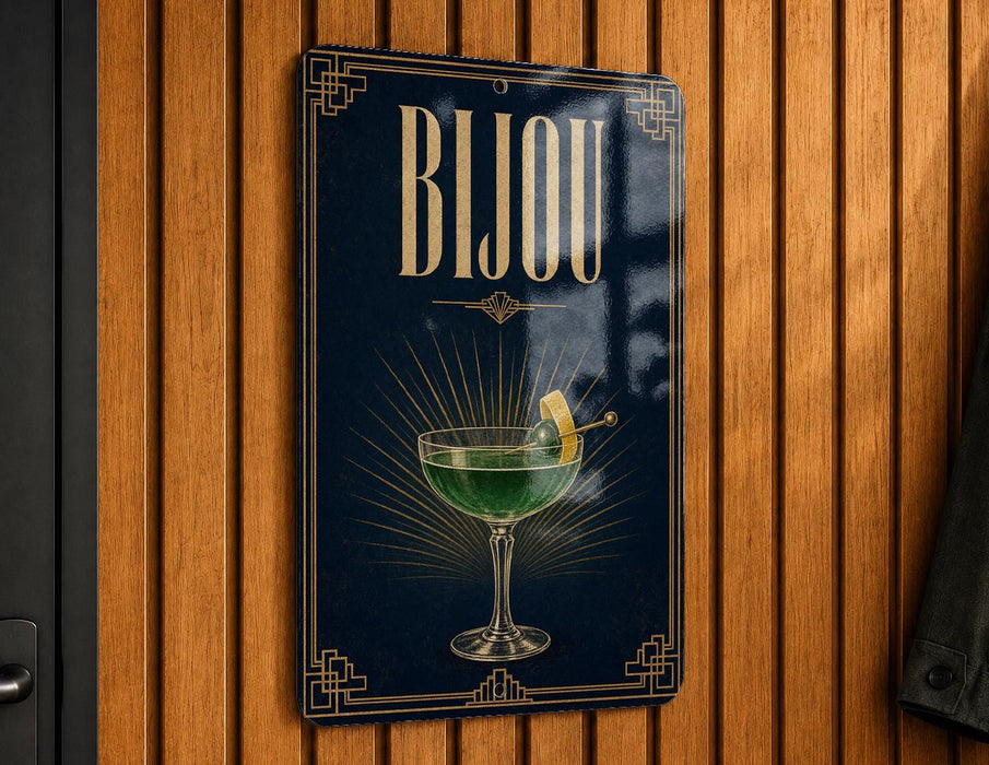 A sign with the word "Bijou" displayed prominently, featuring an illustration of a cocktail glass with a lemon on the side.