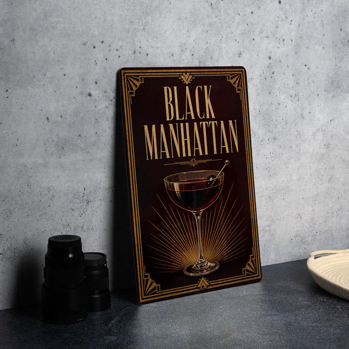 a framed poster with the title "Black Manhattan" on it, along with an illustration of a martini glass.