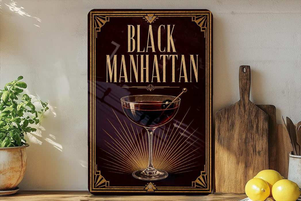 a decorative sign with the text "Black Manhattan" and an illustration of a martini glass with a cherry on top, placed on a wooden surface next to a cutting board and a potted plant.