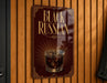 A sign that reads "Black Russian" with an illustration of a glass of Black Russian cocktail.