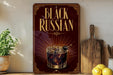a sign with the text "Black Russian" and an illustration of a glass of Black Russian cocktail.